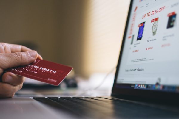 Person holding credit card browsing e-commerce website