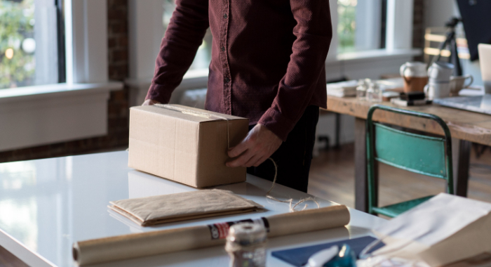 Man standing up and handling a package